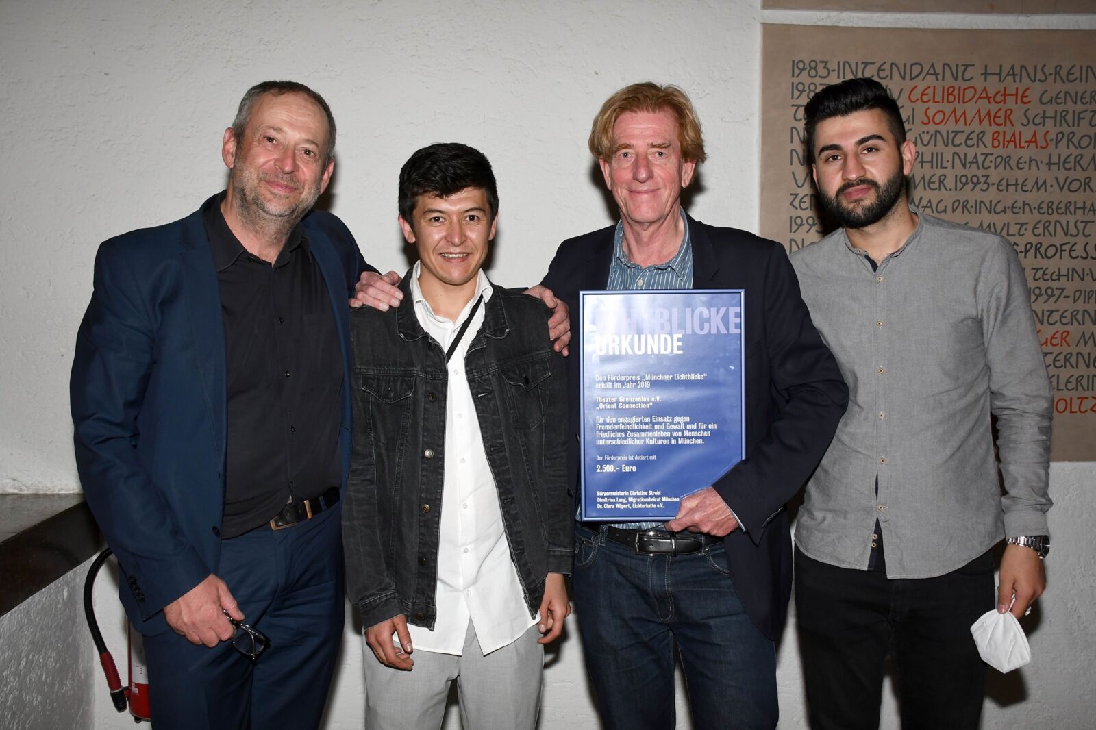 Hier sieht man Julian Franke-Ruthel, Abdul Hakim Rezai, Viktor Schenkel und Hani Ameen Samoo mit der Urkunde für die Auszeichnung "Münchner Lichtblicke".
