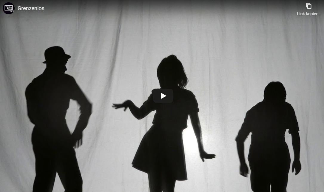 Hier sieht man einen Screenshot des Youtube-Videos "Grenzenlos", auf dem drei SchauspielerInnen im Schattenspiel zu sehen sind.
